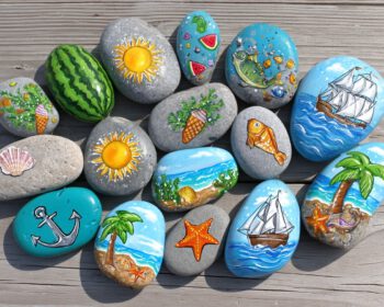 Sammlung bemalter Kieselsteine mit Sonne, Wassermelone, Segelboot, Anker, Fisch und Palmen